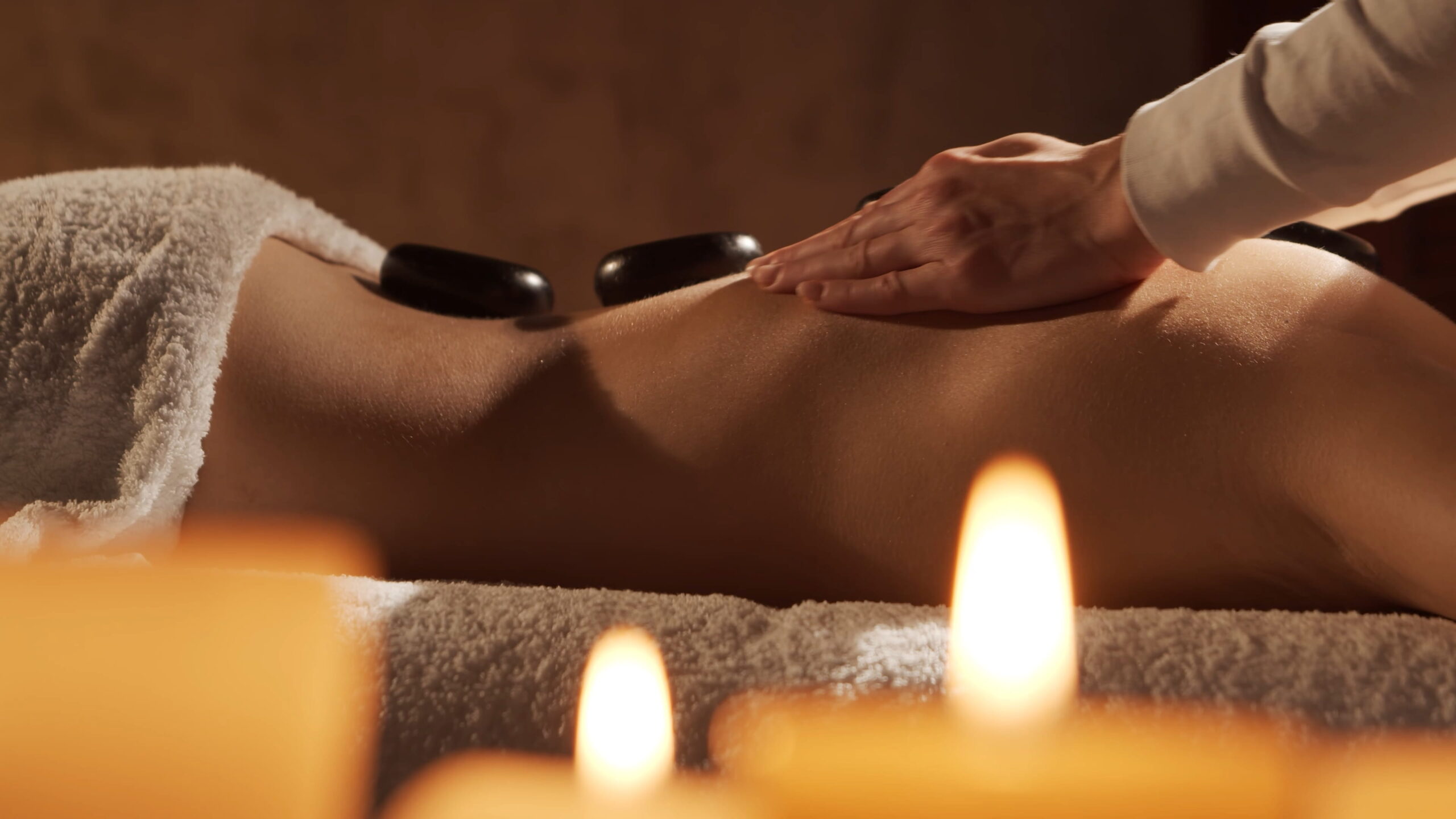 Young, healthy and beautiful woman gets massage therapy in the spa salon. Healthy lifestyle and body care concept.